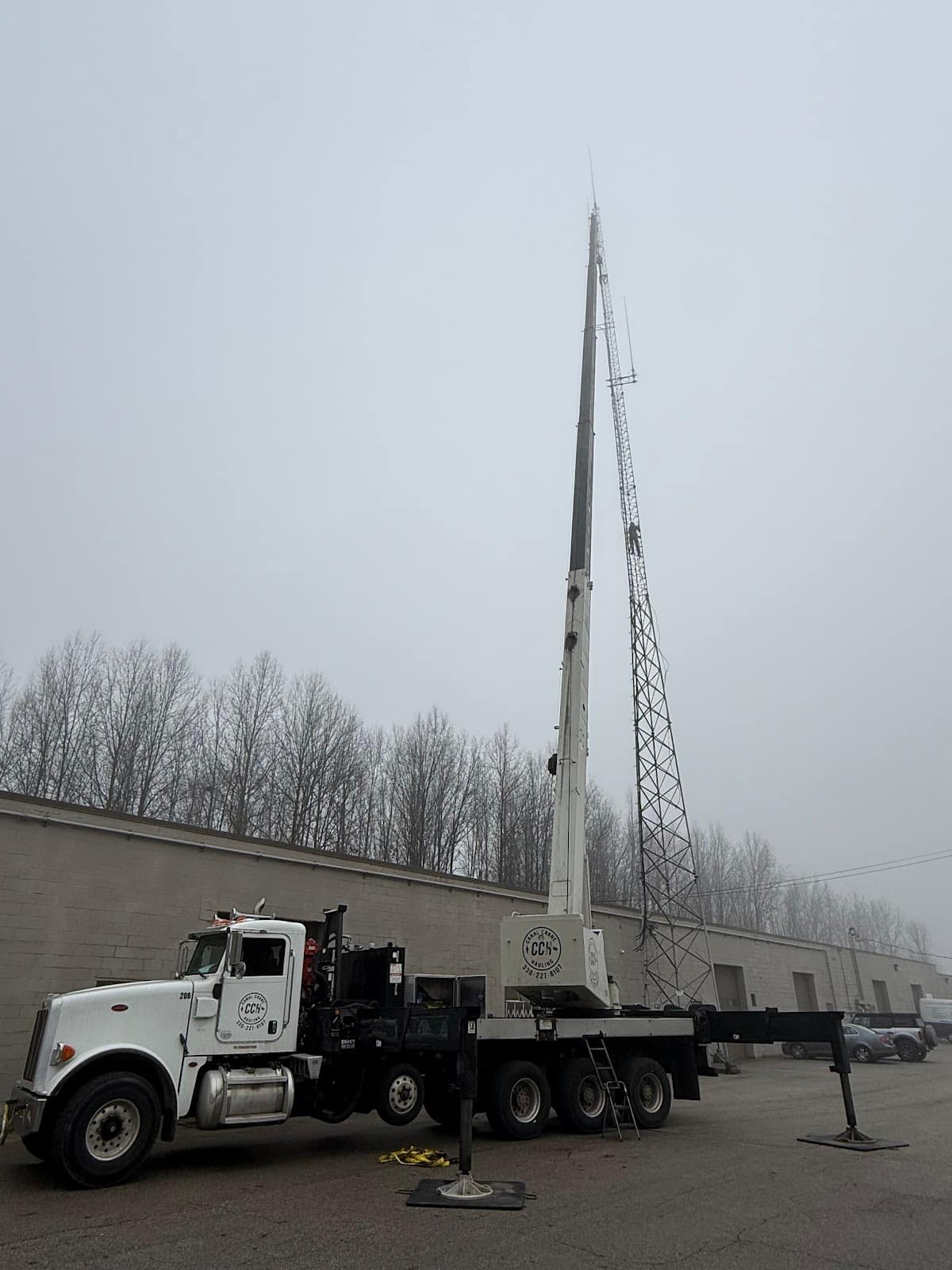 Crane set up with outriggers on a tower job