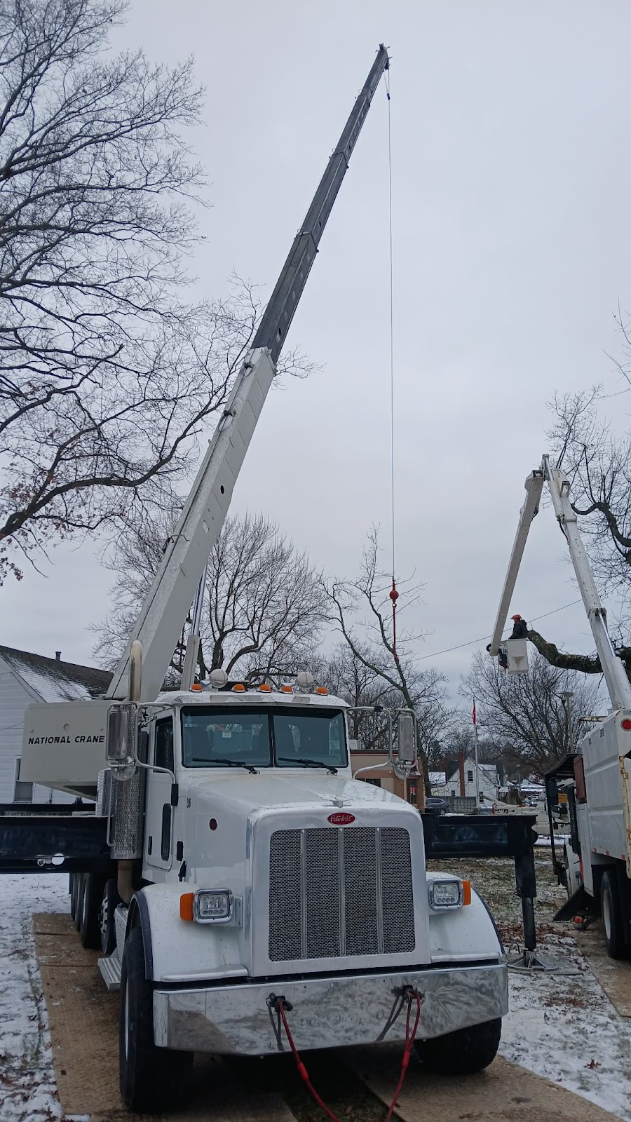 Boom truck on a snowy tree removal